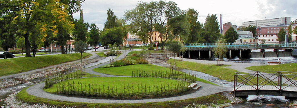 En slingrande promenadstig med ett vattendrag runt.